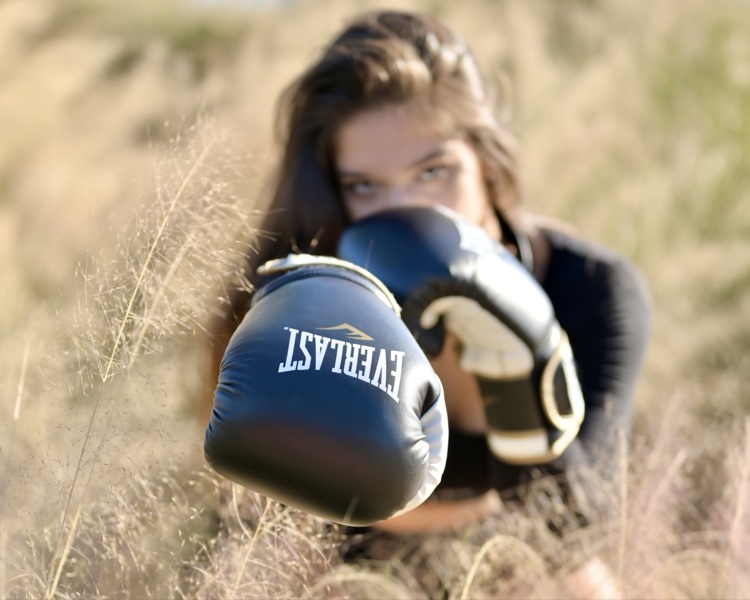 Full-length boxer portrait in a field